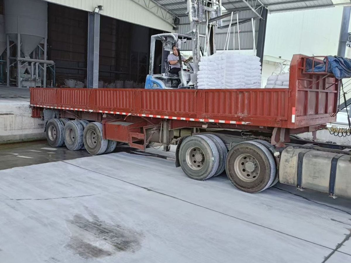 Forklift loading bagged mineral materials onto a truck at Xinruifeng’s facility