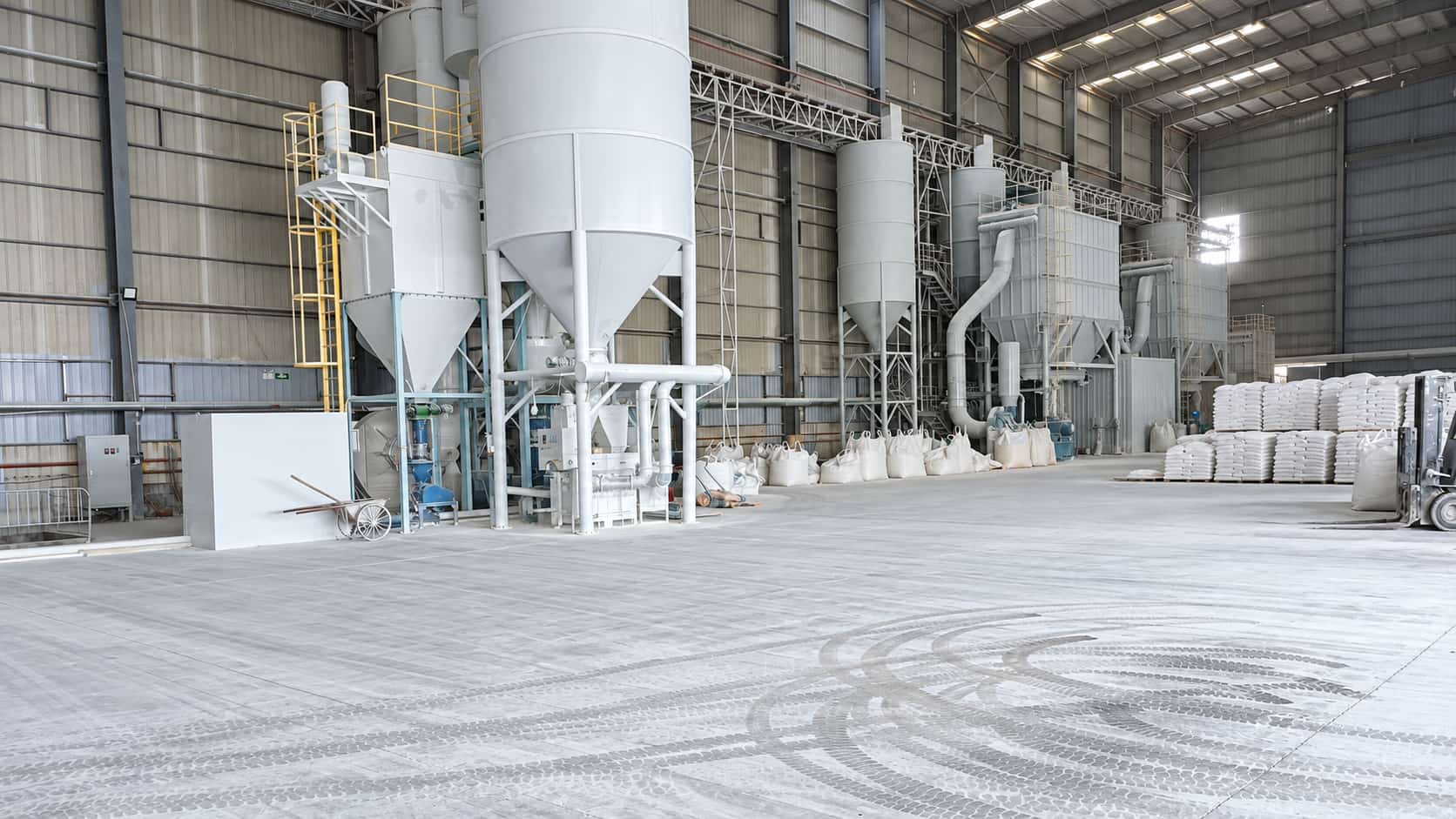 Mineral powder processing equipment and bagged materials inside Xinruifeng's production facility