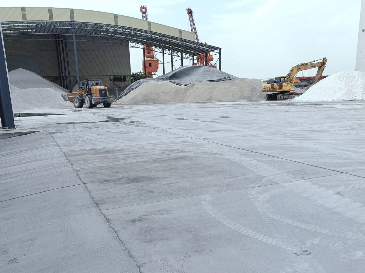 Factory buildings and raw material stockpiles at Xinruifeng’s production site